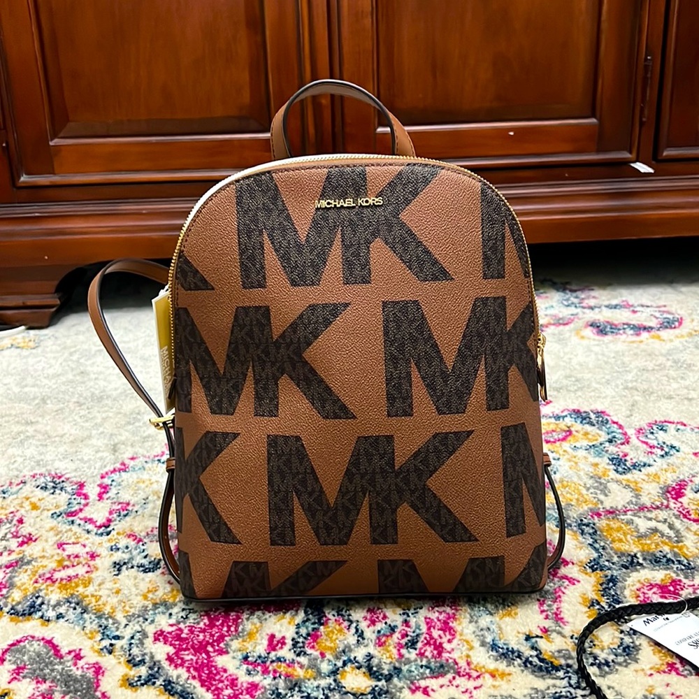 Michael Kors, backpack brown background with large black logo design pattern